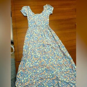 Feminine blue dress featuring pink and beige floral pattern.